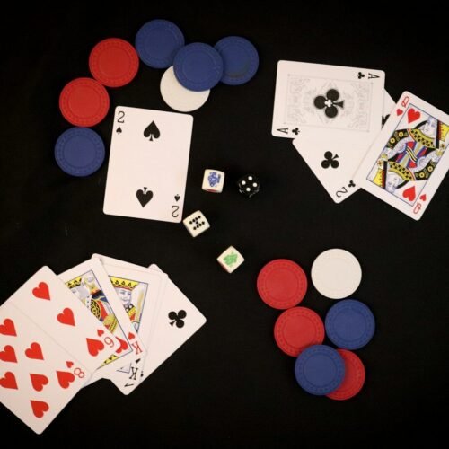 playing cards and dice on a black background